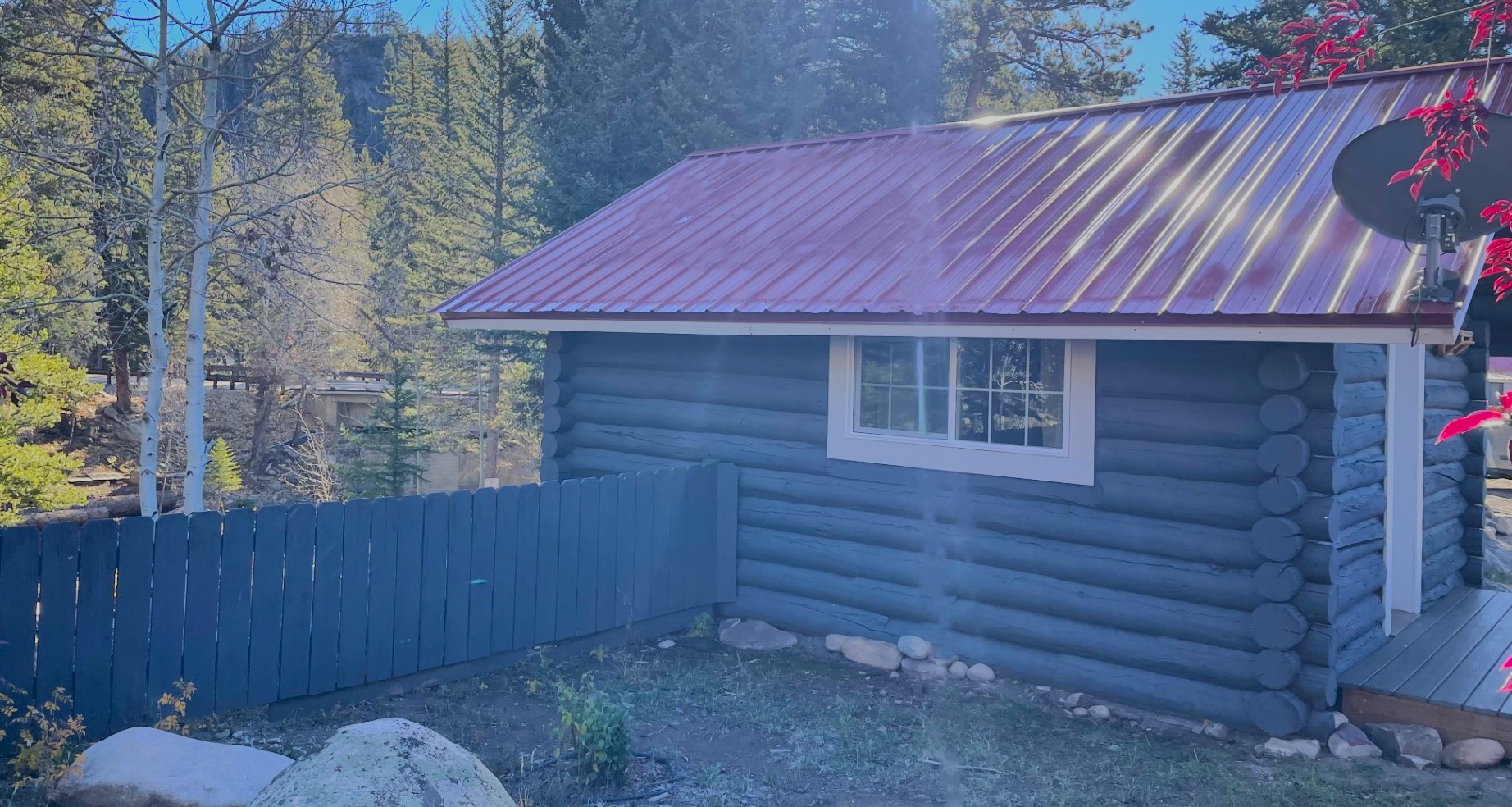 Cabin 4 Exterior Side View Blue Fence