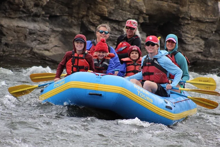Family rafting through canyon rocks