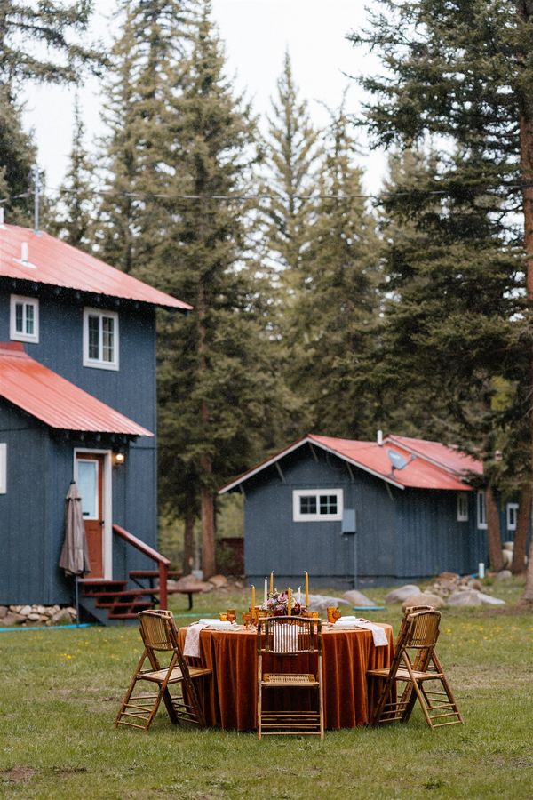 Dinner table set on the lawn in front of the cabins