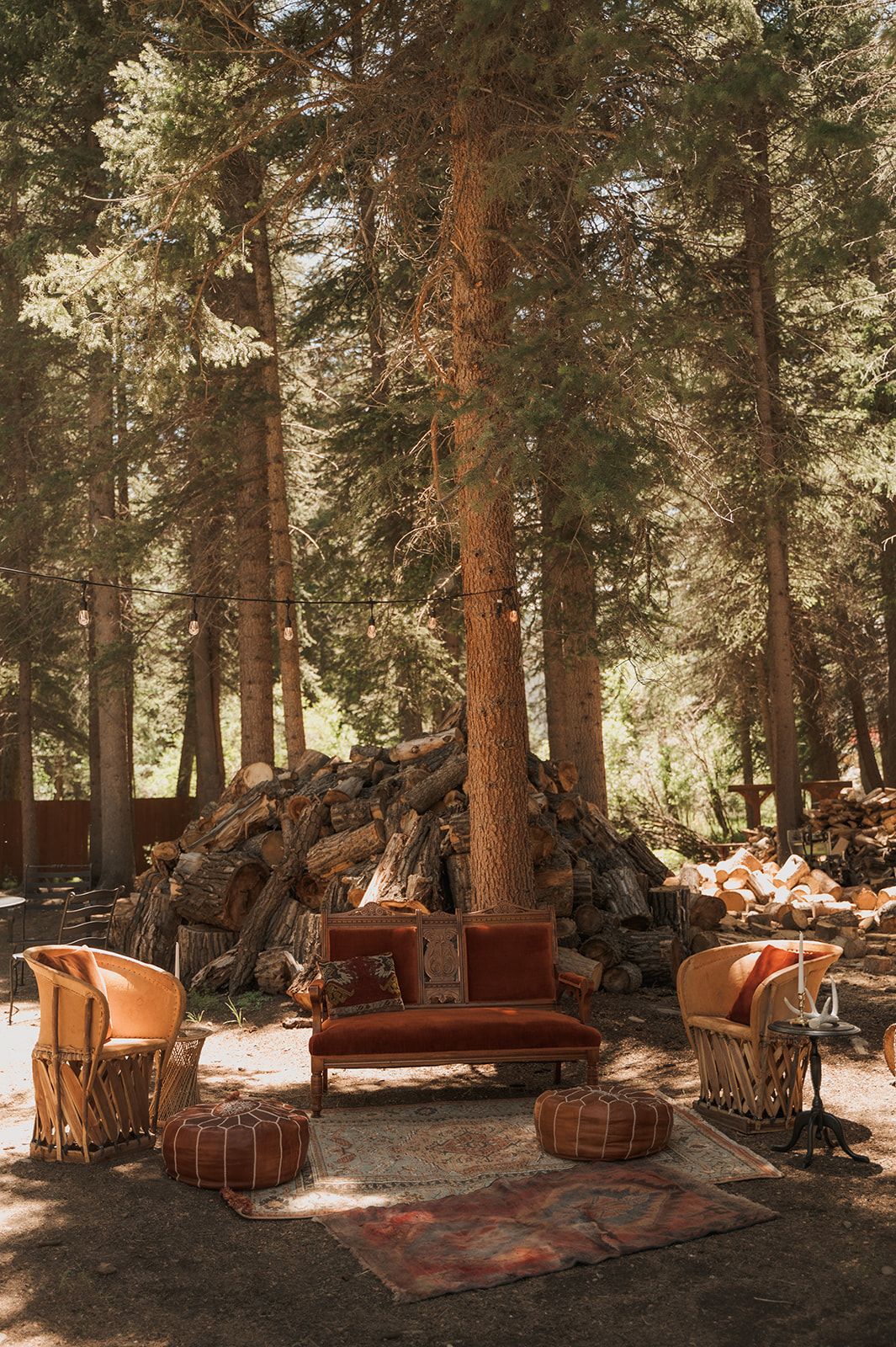 Velvet settee, leather chairs and rugs under the pines at the Cookout Grounds