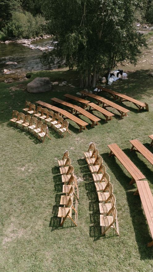 Aerial view of ceremony benches on the Meadow beside the river
