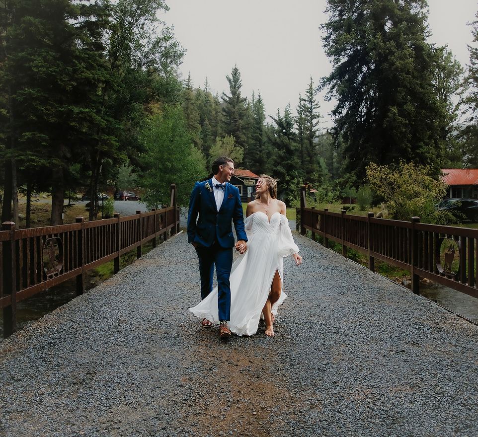 Bride and groom walking the bridge path