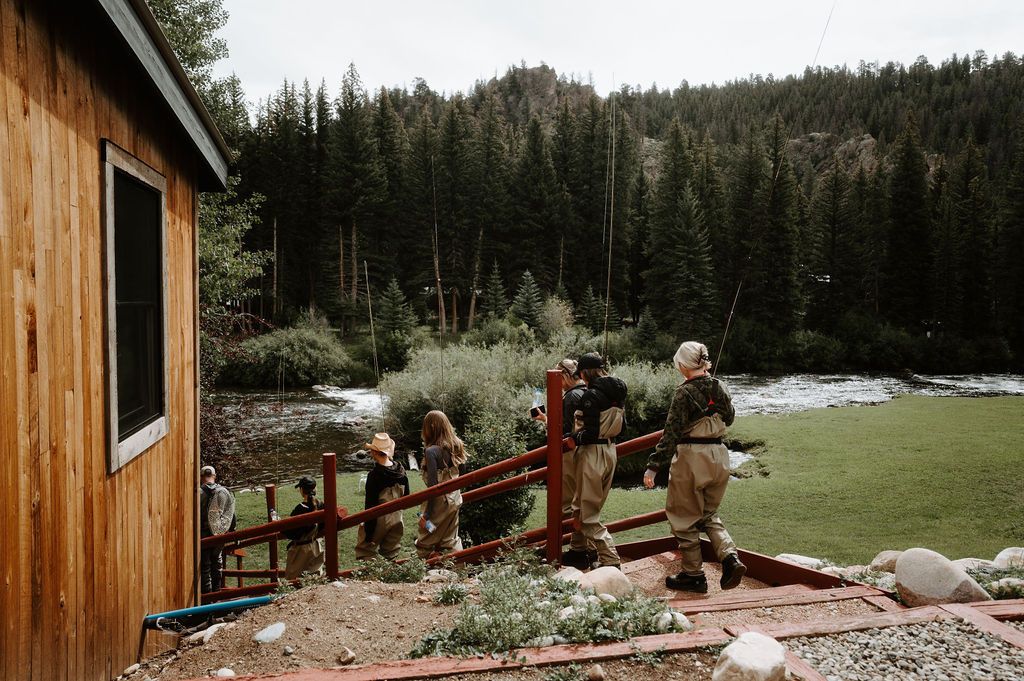 Anglers in waders walking down to the Taylor River