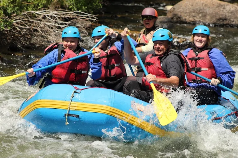 Whitewater rafting crew paddling